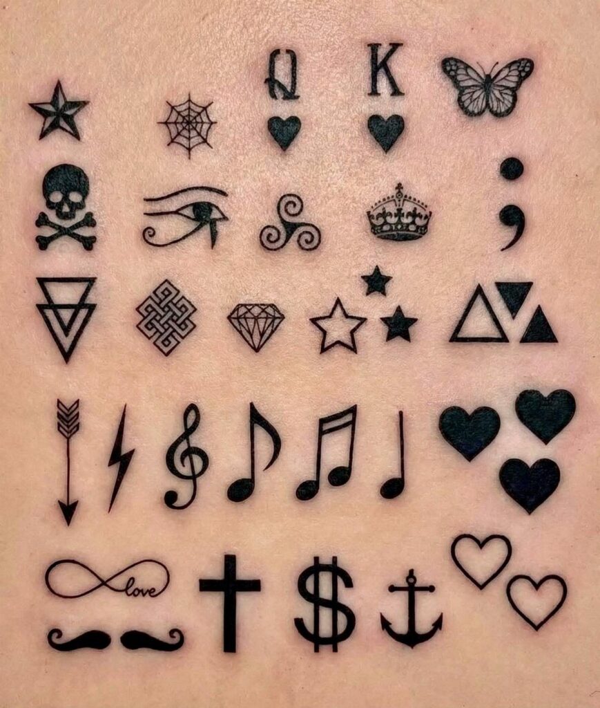Various small black line art tattoos including symbols and musical notes on skin.